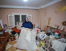 Eine Frau zeigt Ihre Nähprodukte