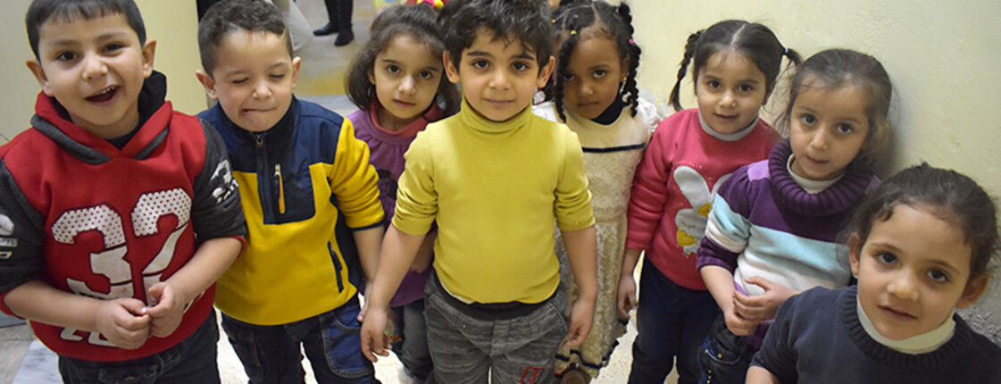 Eine Gruppe Kinder steht im Halbkreis
