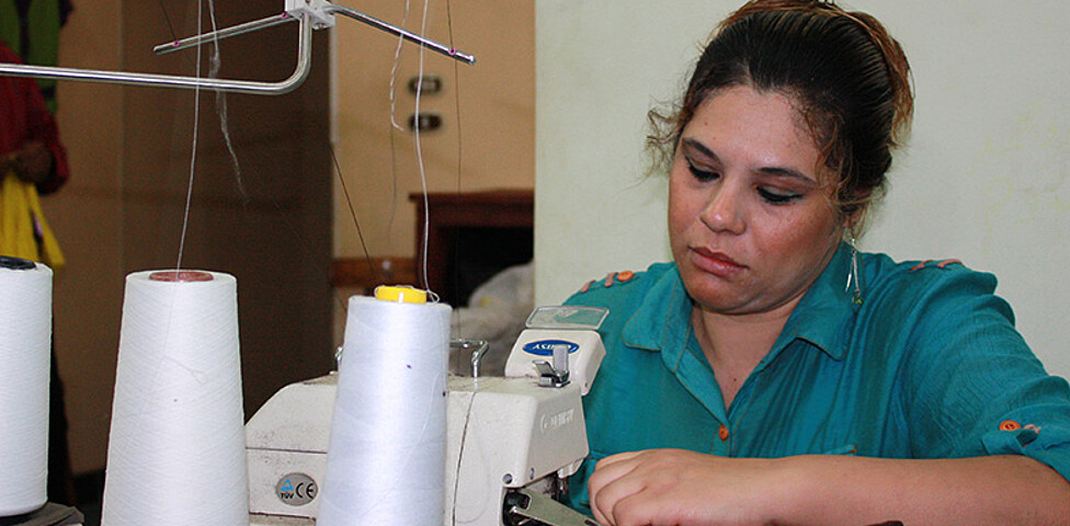 Eine ägyptische Frau in ihrer Werkstatt in Kairo an der Nähmaschine